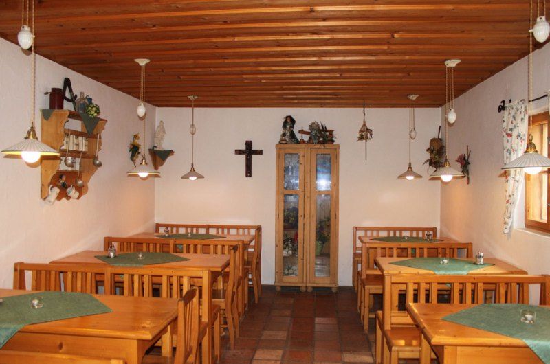 Interior view of a rustic wine bar with wooden furniture and decorations.