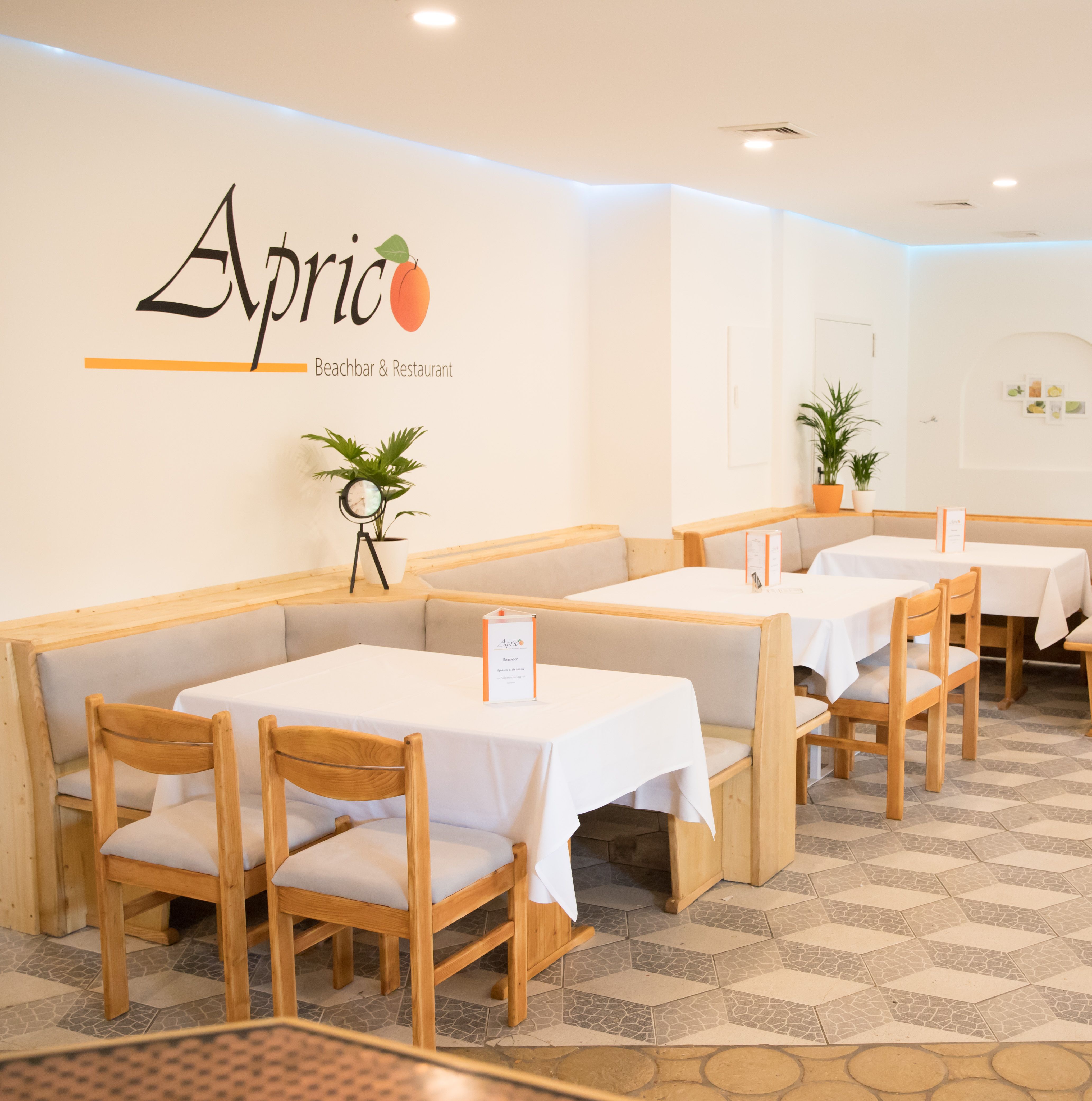 Guest room with tables and chairs and white table linen 