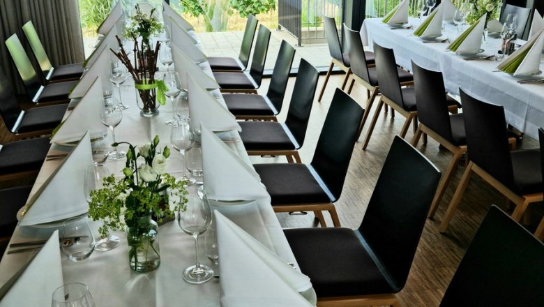 Elegant table setting in a room with a view of the vineyards.
