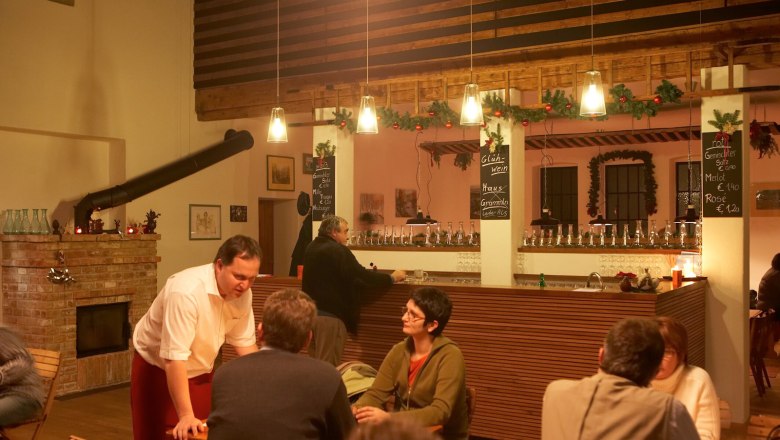Interior view of a cozy pub with bar and guests.