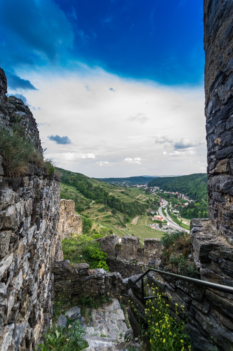 View of a green landscape with a village in the valley from the ruins of Senftenberg Castle.