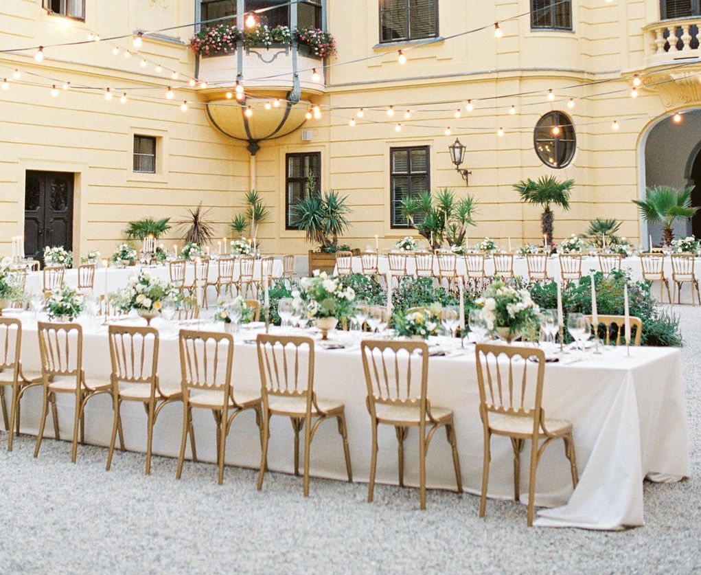 Inner courtyard of Eckartsau Castle with festively laid tables and fairy lights.
