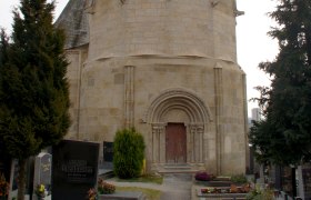 Karner Pulkau, a historic building with a pointed roof, surrounded by a cemetery.