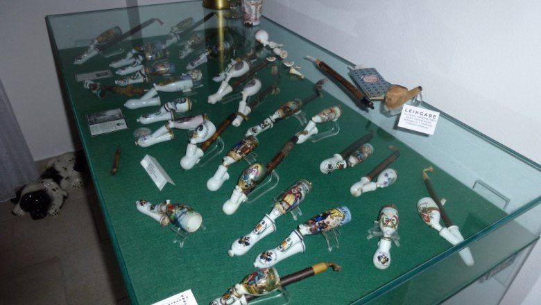 Display case with decorative pipes in a museum.