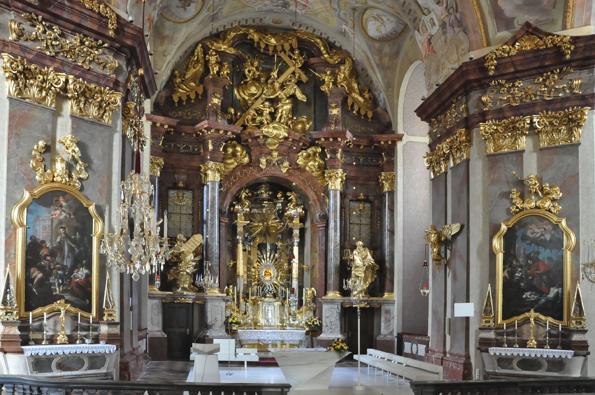 Chancel of Maria Taferl Basilica with richly decorated baroque altar and golden ornaments.