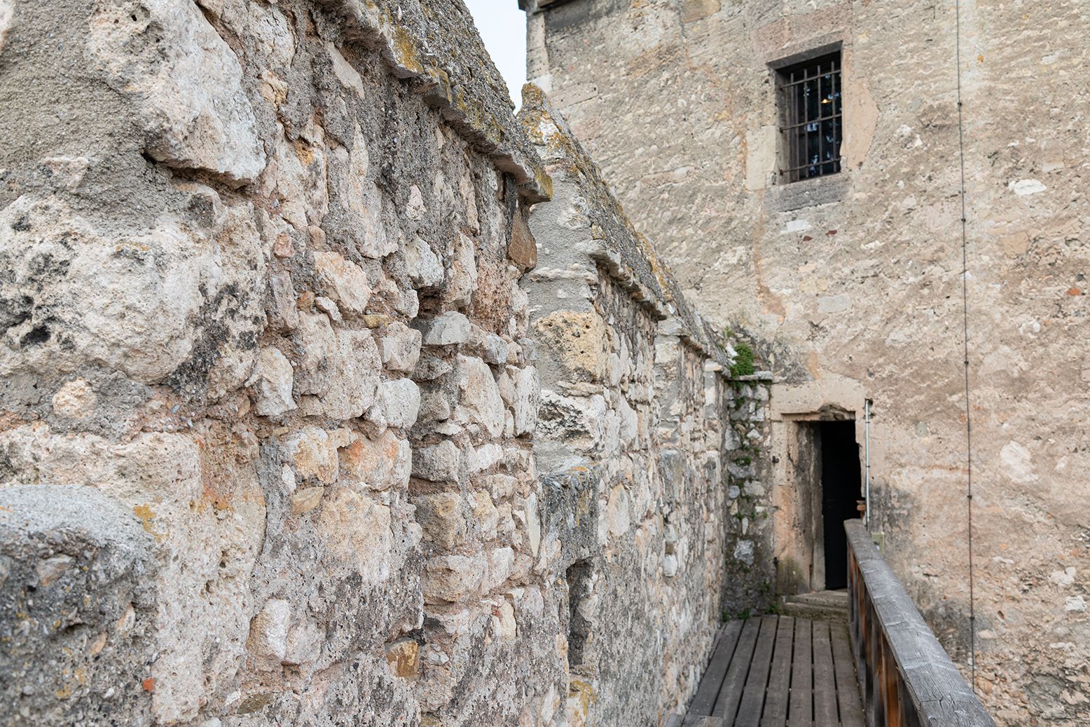 Stone city wall with wooden floor and door.