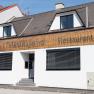 Façade of a restaurant called Piestingerhof, decorated with fairy lights.