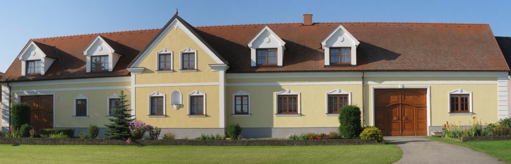 Yellow house with red tiled roof and several windows, surrounded by a well-kept garden.