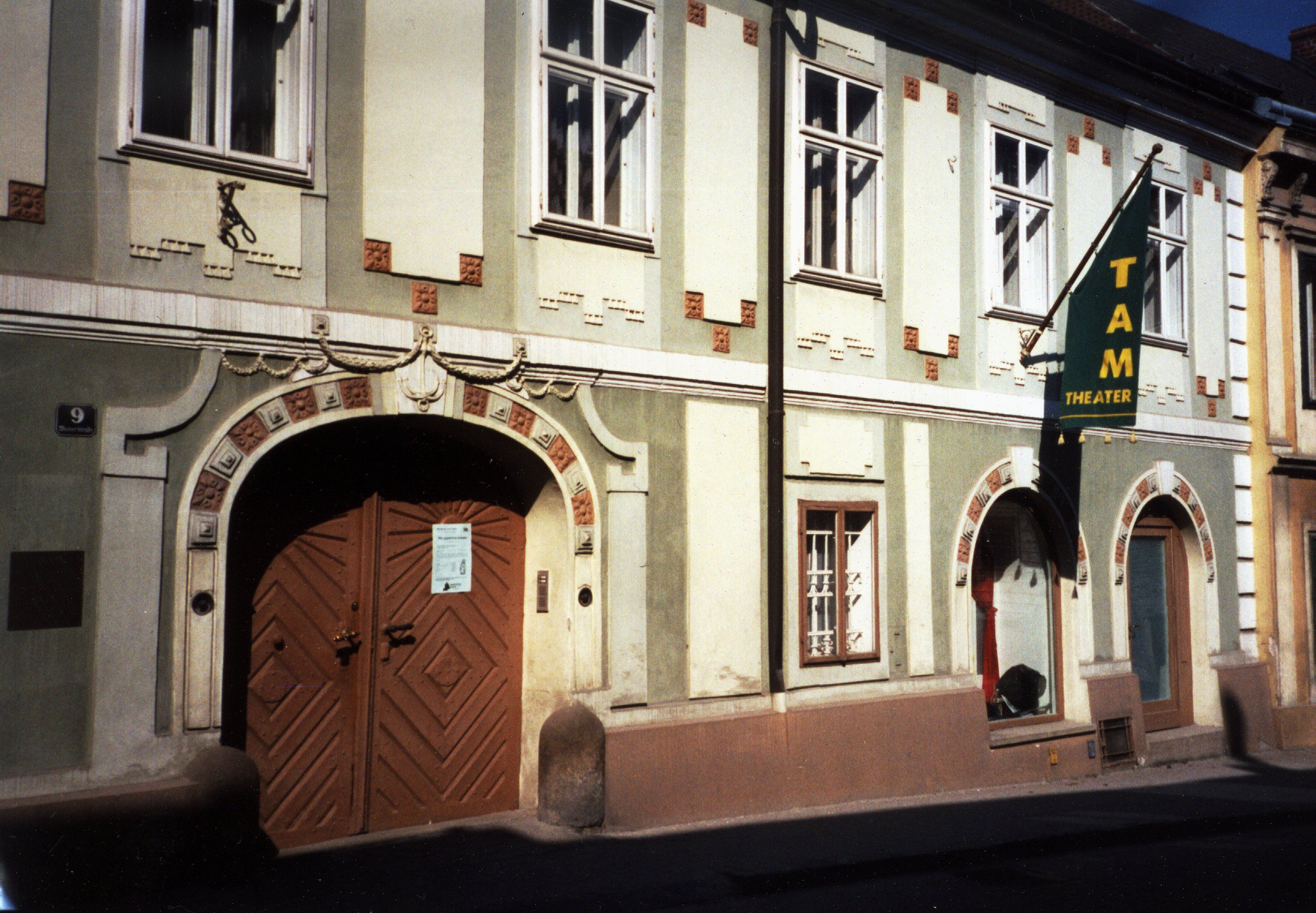 Facade of the TAM - Theater an der Mauer with entrance door and windows.