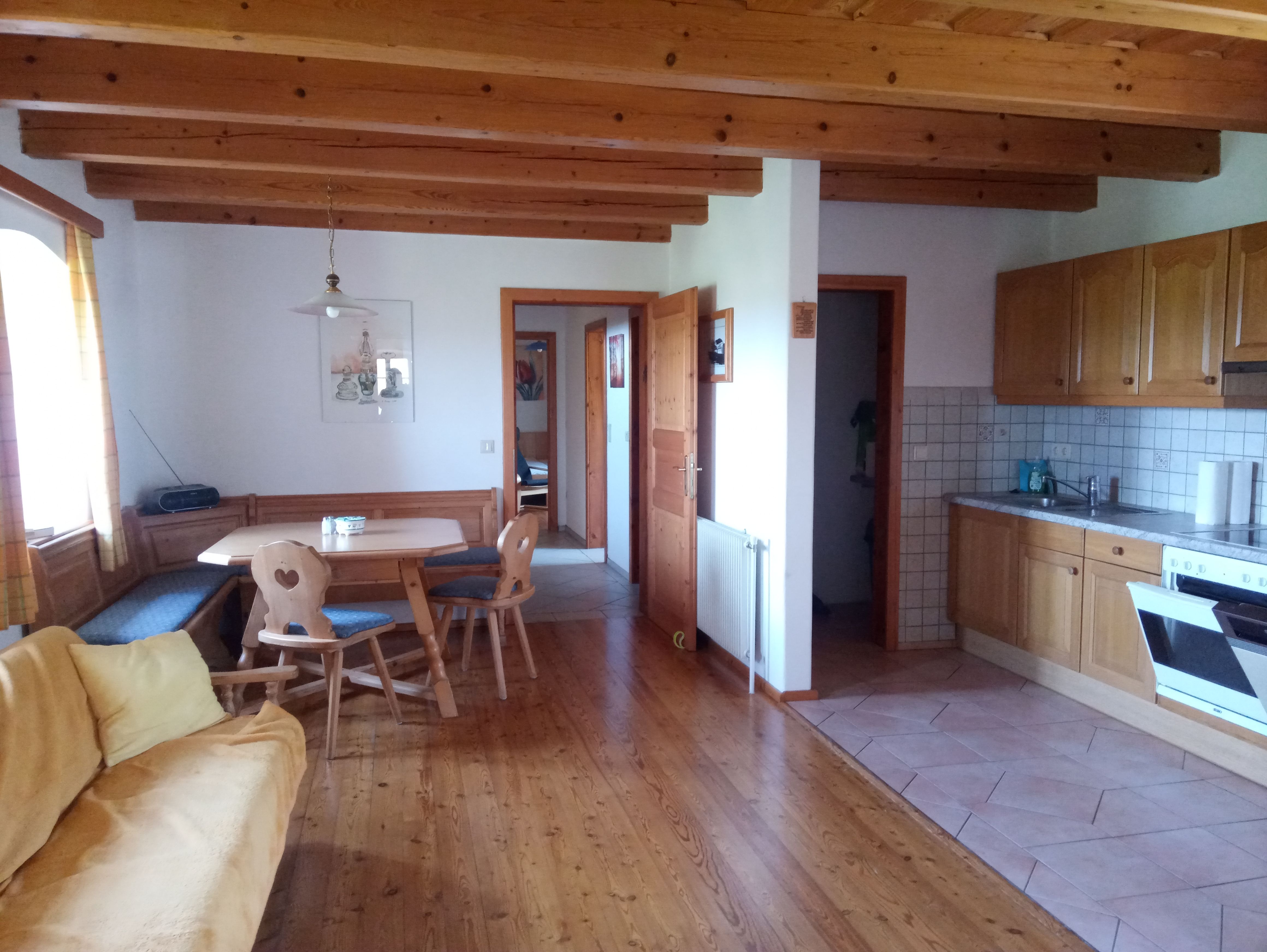 Cozy vacation apartment with wooden furniture and kitchen.