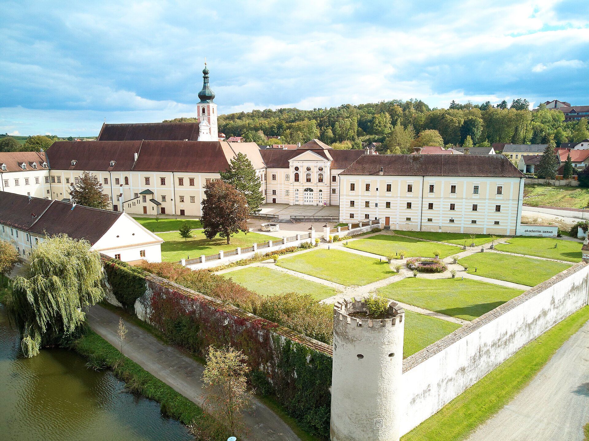 Aerial view of Geras Abbey with garden and tower in the foreground.