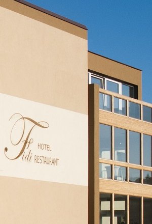Exterior view of a modern building with the inscription 'Fidi Hotel Restaurant'.