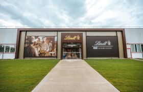 Entrance to the Lindt Factory Outlet with large advertising banners.