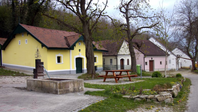Wine cellar lane in Absdorf with colorful houses and trees.