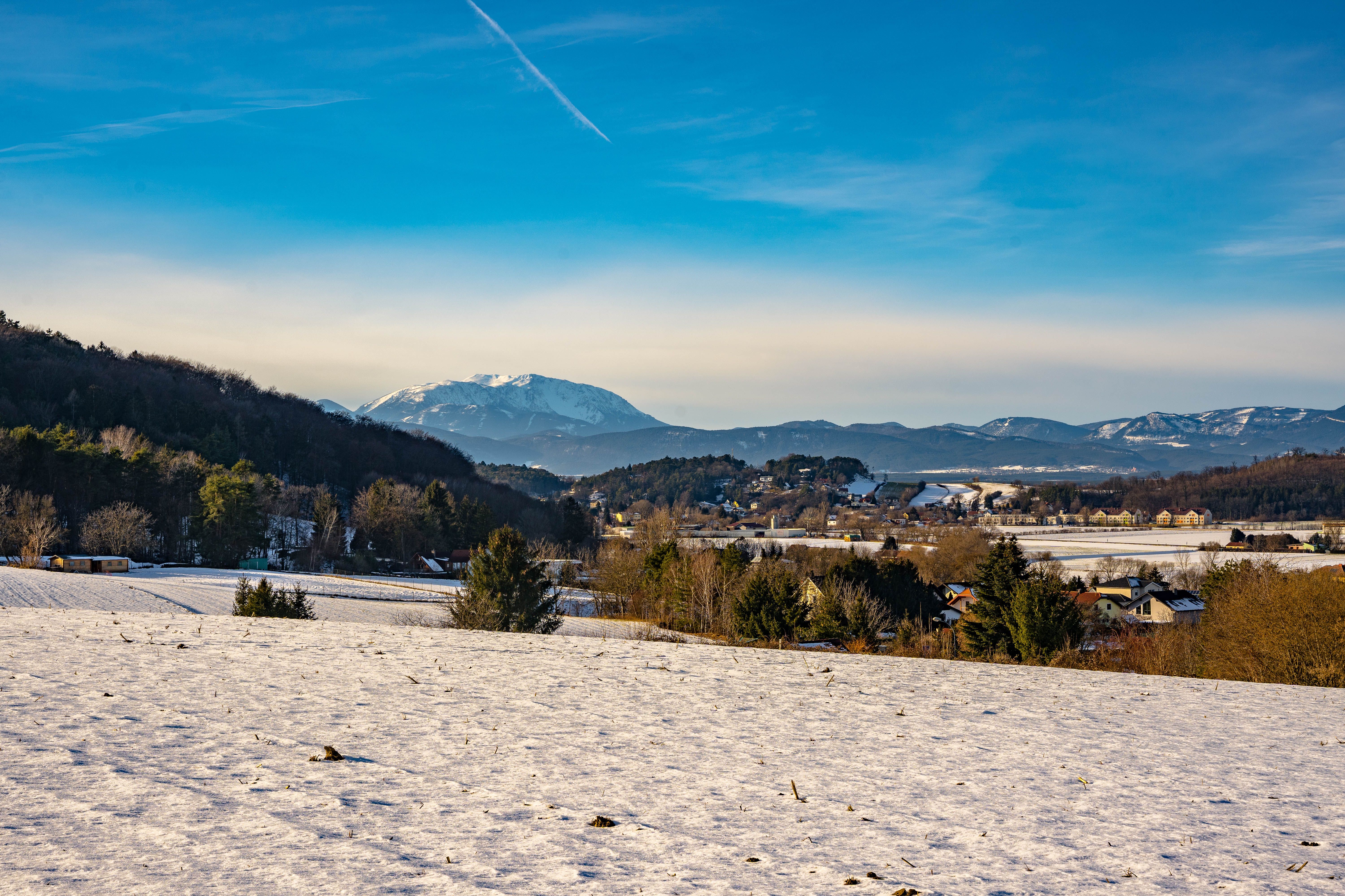 Winter landscape with snow-covered fields and Schneeberg, in the background in Bad Erlach.