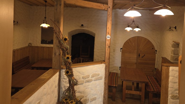 Cozy interior of a rustic inn with wooden furniture and decorations.