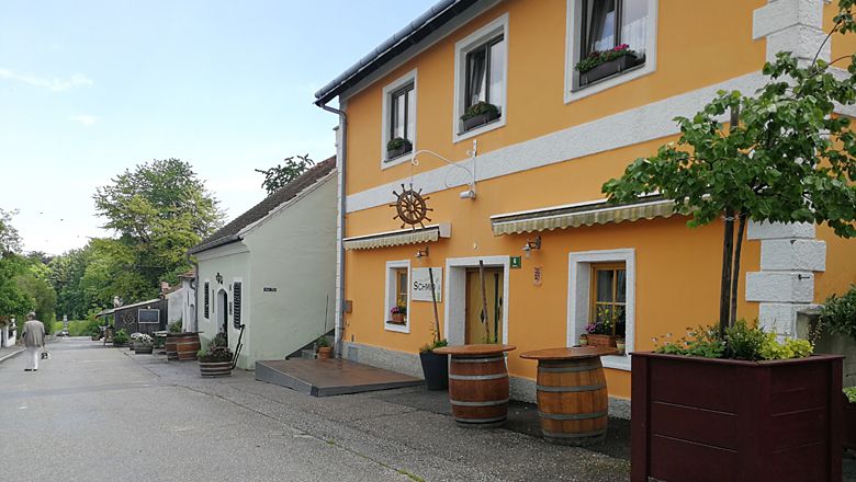 A picturesque street with traditional houses and wine barrels in Langenlois.