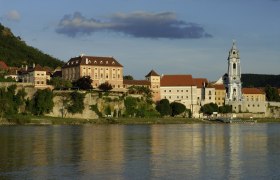 Exterior view of Dürnstein with castle and church on the riverbank.