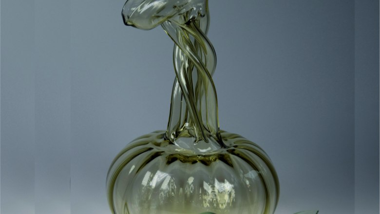 Glass object with twisted shapes on a gray background.
