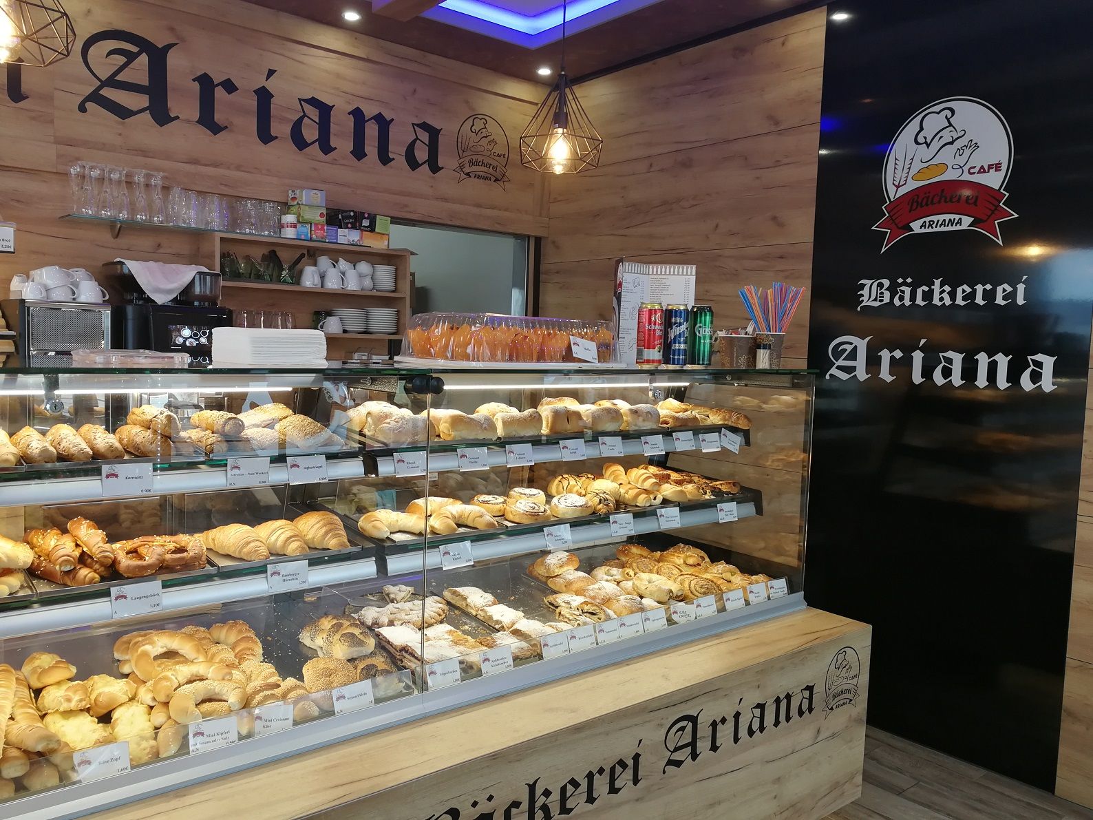 Interior view of the Ariana bakery with a display full of baked goods.