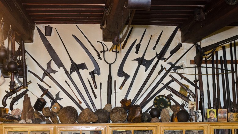 Wall with historical weapons and artifacts in the local history museum.