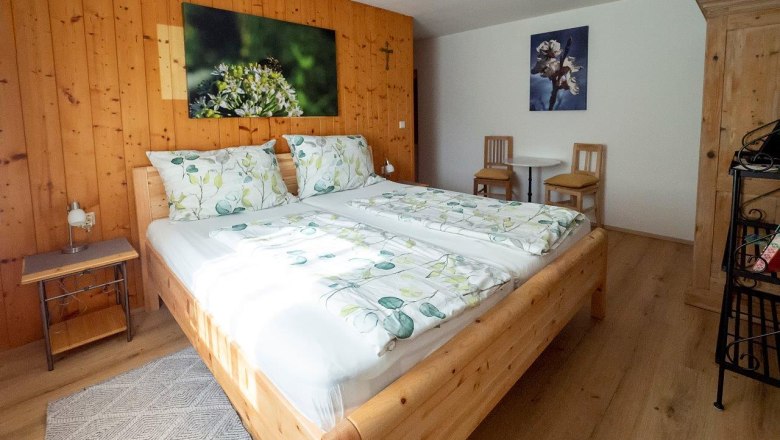 Cozy bedroom with wooden furniture and double bed.