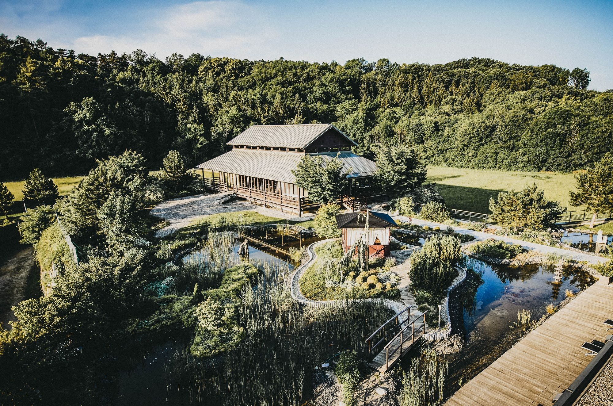 Exterior view of the Linsberg Asia Resort with its garden and pond.