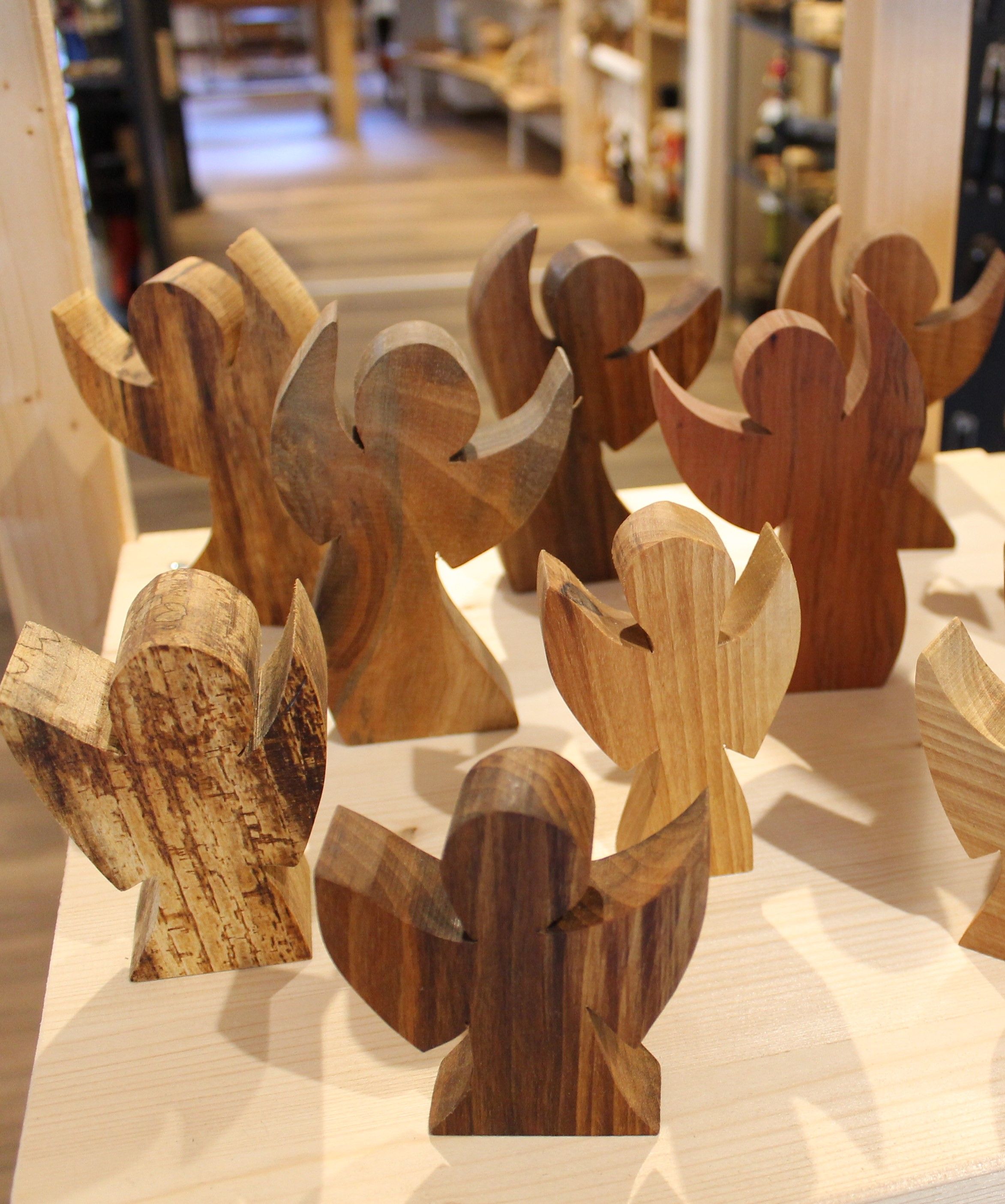 Wooden angel on a table in a store.