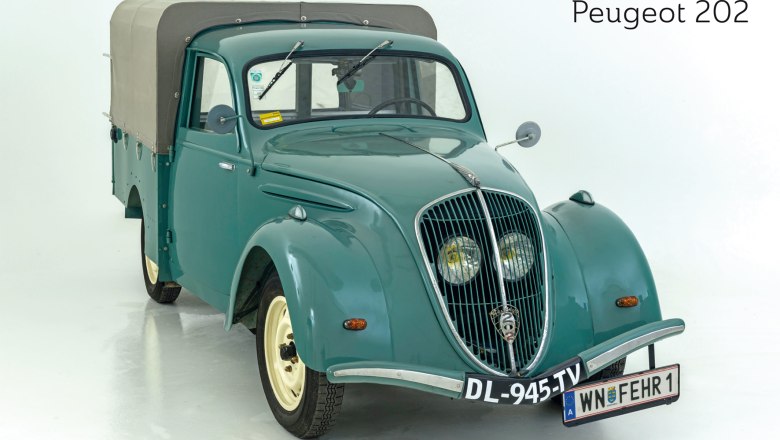 A green Peugeot 202 with tarpaulin, photographed from the front, on a white background.