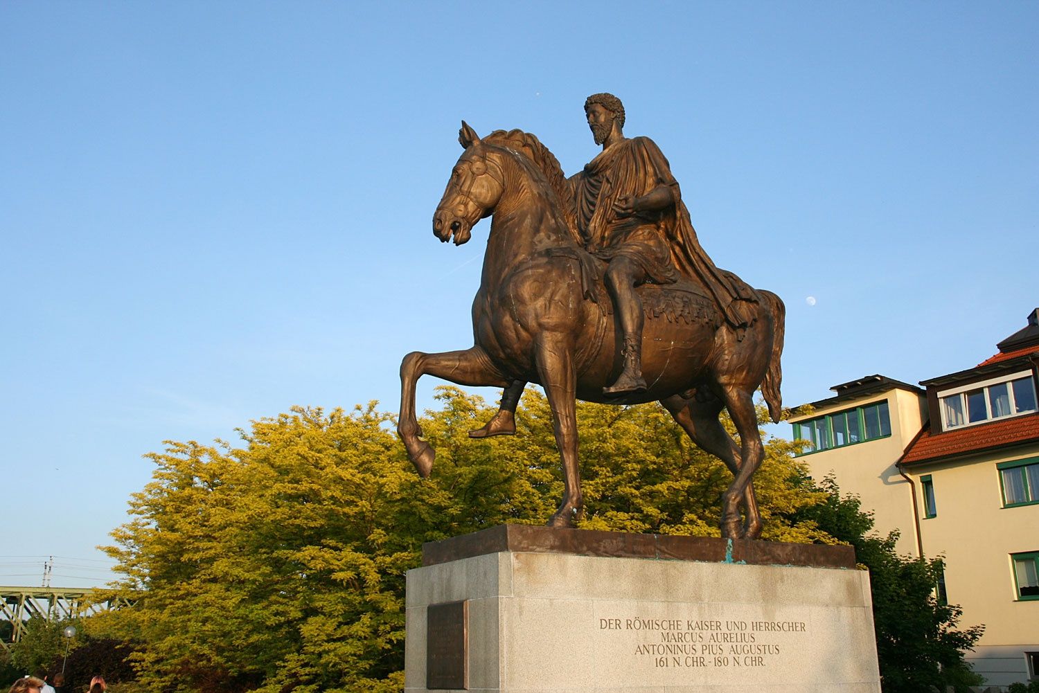 Equestrian statue of Marcus Aurelius on a pedestal in front of a blue sky.