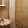 Bathroom with shower area, washbasin and shower curtain.