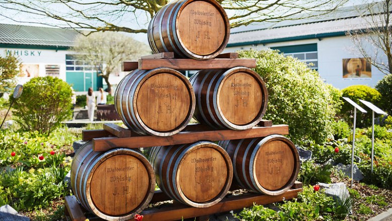 Pyramid-shaped wooden barrels in the garden of the Haider whisky experience.