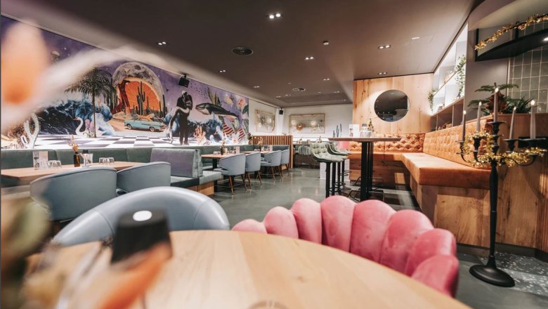 Interior view of a stylish restaurant with modern furnishings and wall art.