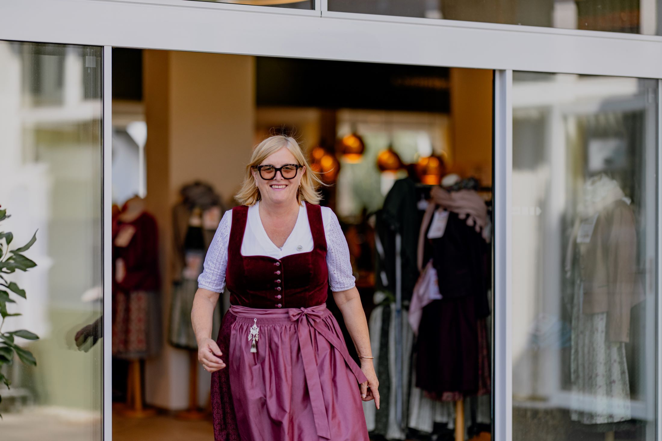 Woman in traditional costume leaving a clothing store.