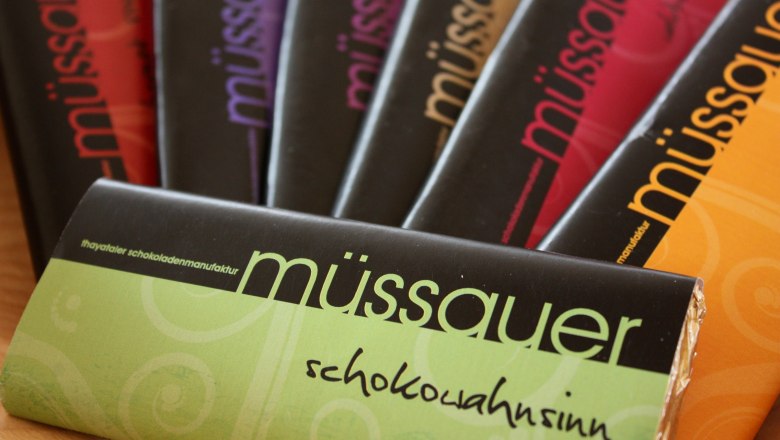 Various M&uuml;ssauer brand chocolate bars in colorful packaging.