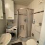 Bathroom with shower, washbasin and washing machine
