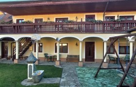 Inner courtyard with arcades, balcony, swing and fountain.