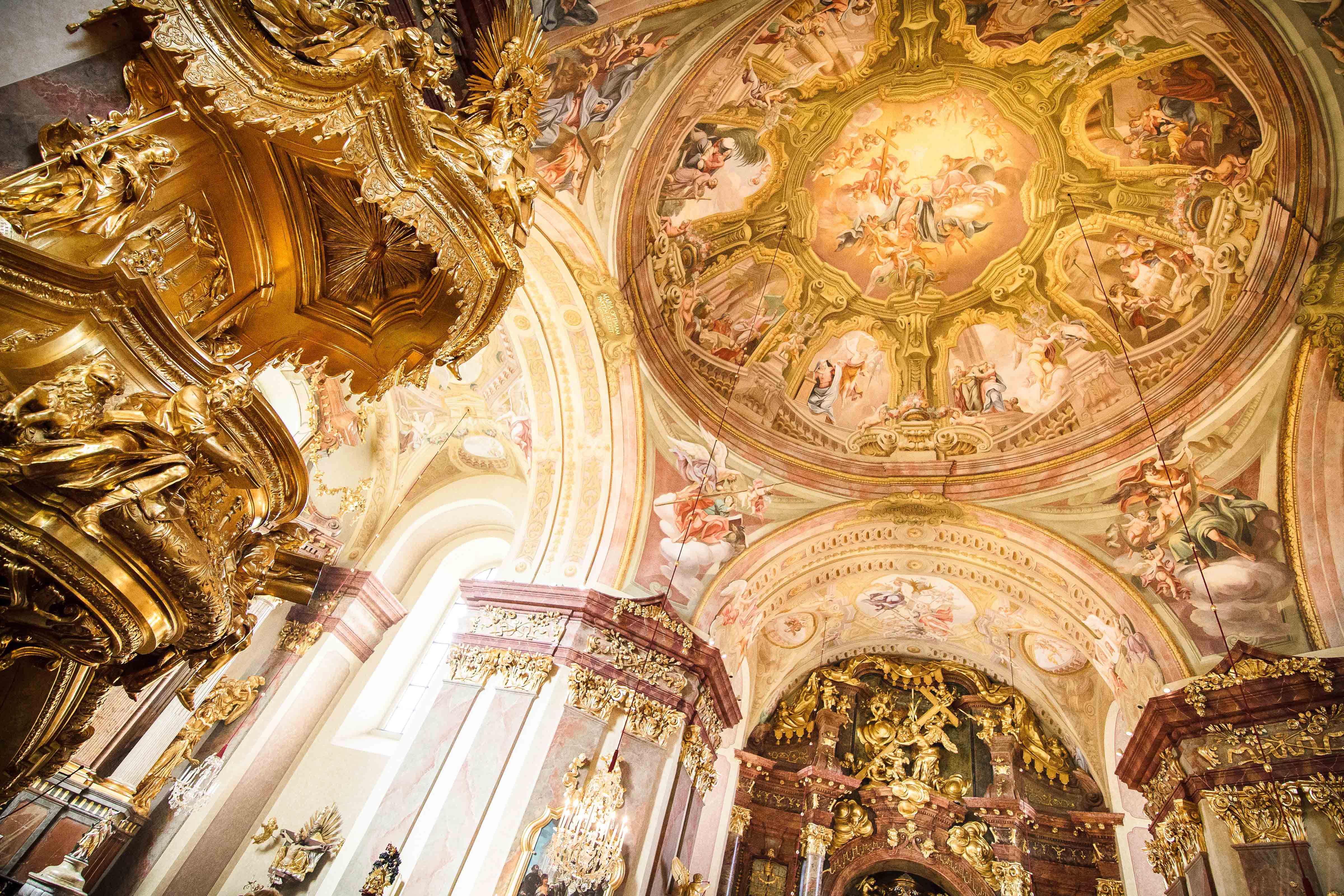 Interior view of Maria Taferl Basilica with richly decorated golden elements and frescoes on the ceiling.