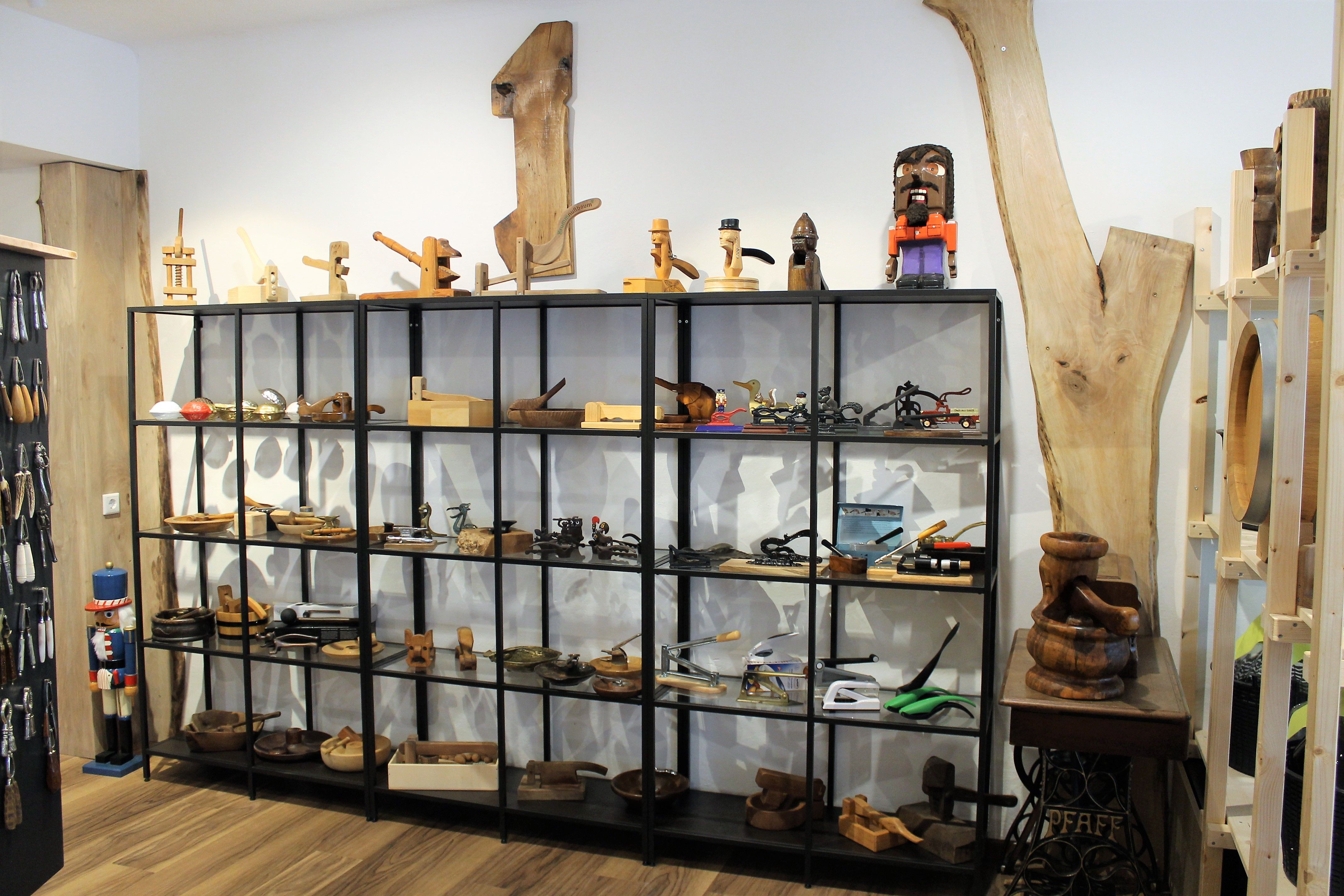 Shelf with wooden objects and tools in a showroom.