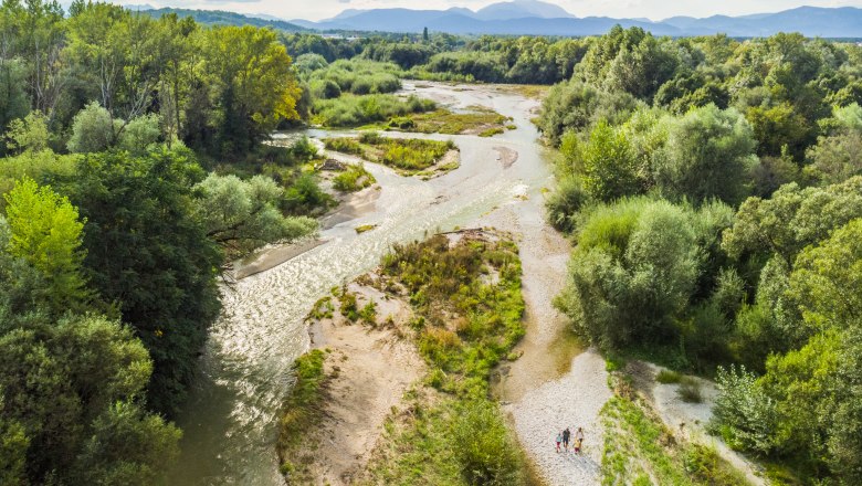 Aerial view of the source of the Leitha in Lanzenkirchen with river and green vegetation.