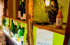 Shelf with wine bottles and decoration in a wine bar.