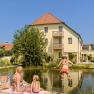 A woman and two children at the bathing pond in the ad vineas guest house