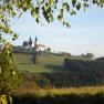 Landscape with Maria Taferl church on a hill, surrounded by trees and meadows.