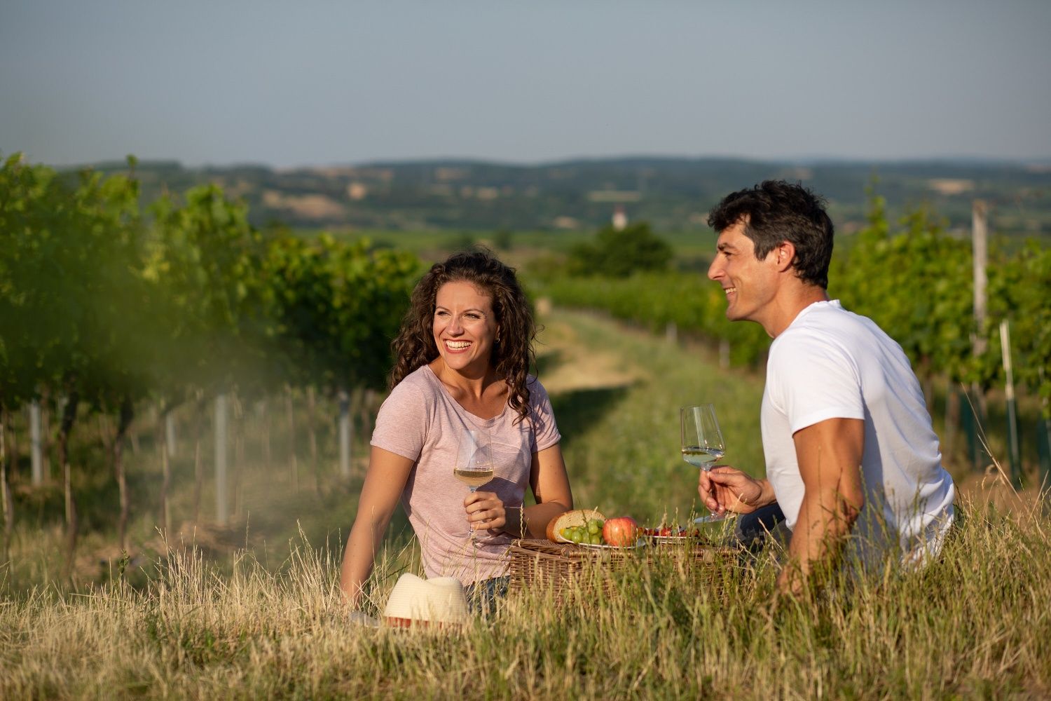 Couple having a picnic in the vineyard