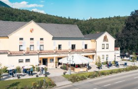 Theater Reichenau with people and parasols in front of it.
