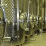 Row of stainless steel tanks in a wine cellar.