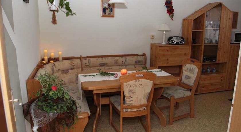 Cozy dining area with wooden furniture and corner bench.