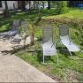 Four sun loungers on a terrace in the garden.