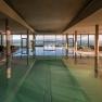 Indoor pool with panoramic views of the mountains and countryside.