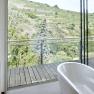 Bathroom with free-standing bathtub and view of vineyards.